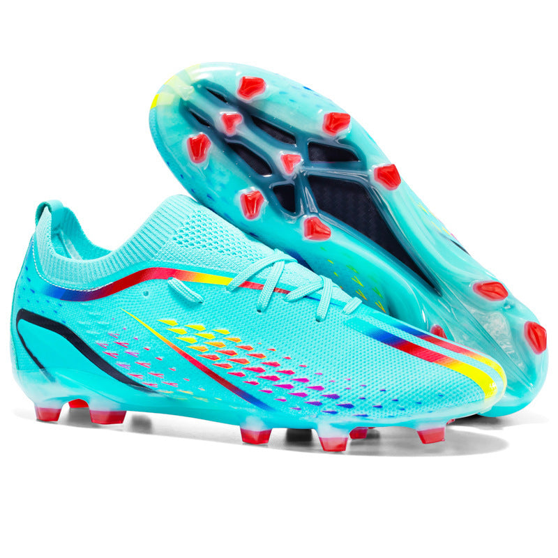 Turquoise soccer cleats with red studs on a white background