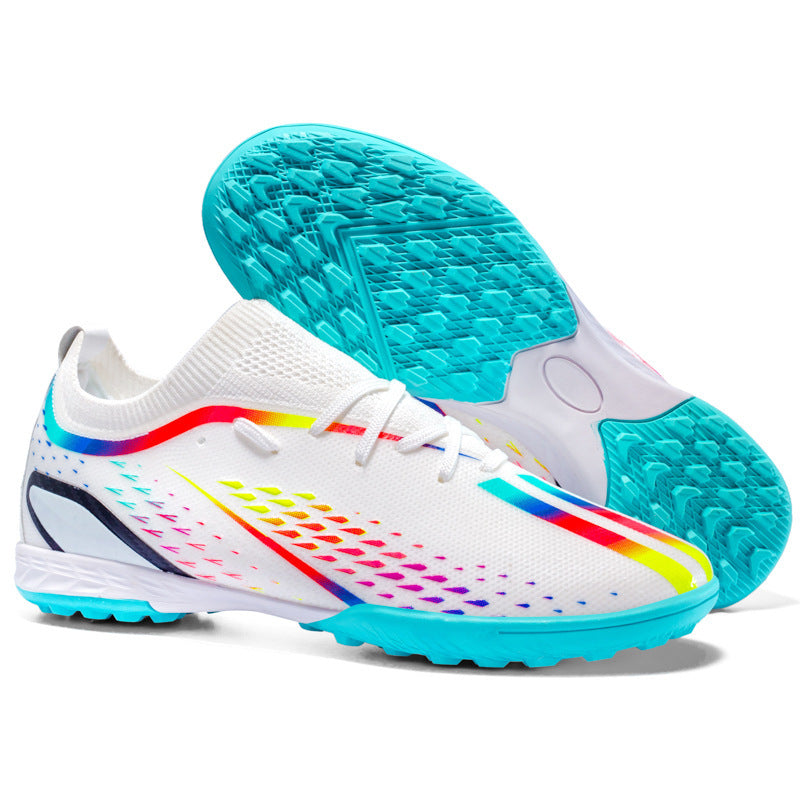 White soccer cleats with colorful sole and blue outsole on a white background